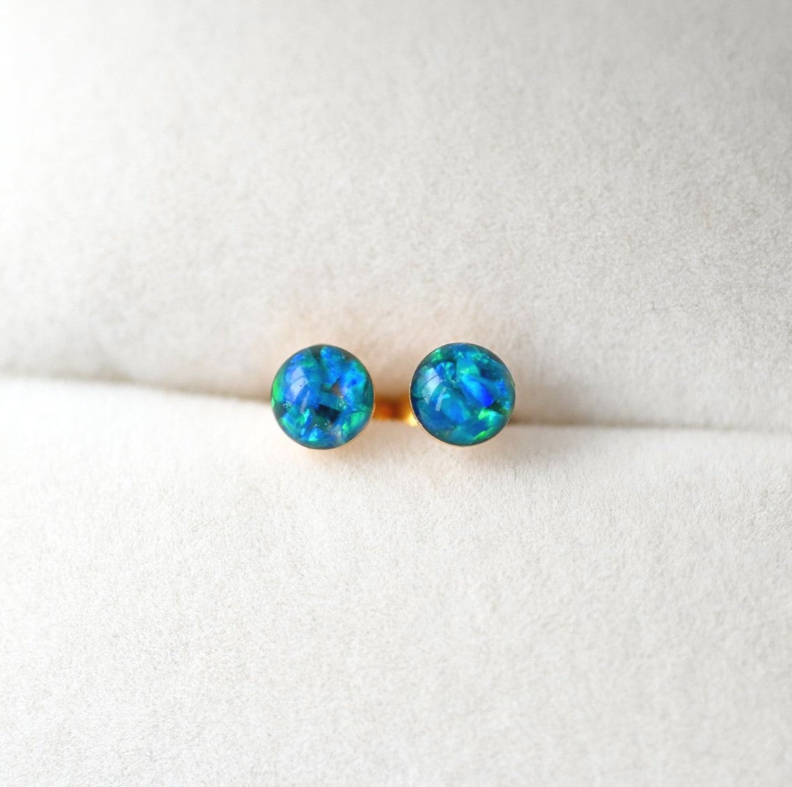 Dainty 4mm memorial earrings, featuring cremation ashes and shimmering opal flakes in a silver or gold-filled setting.