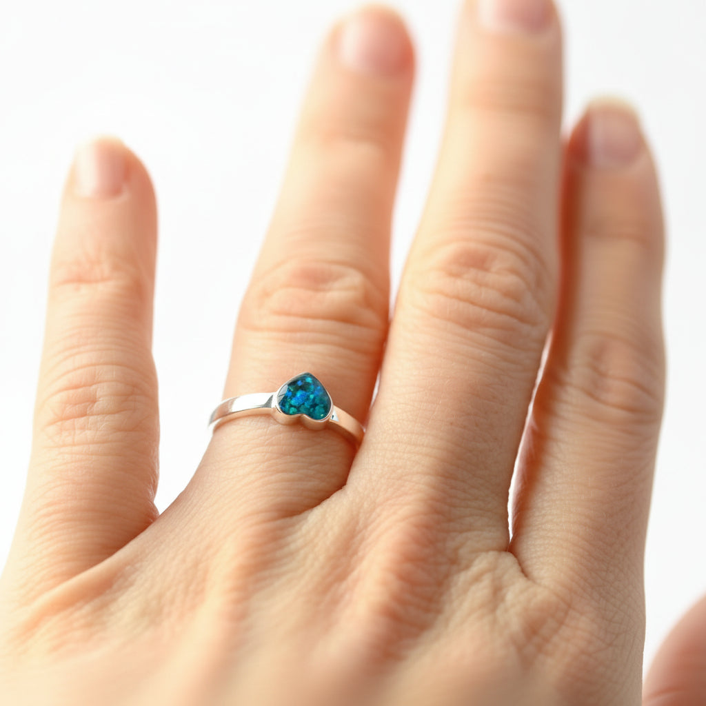 Memorial jewellery gift – a 6mm heart-shaped ring with ashes and opal flakes in sterling silver.