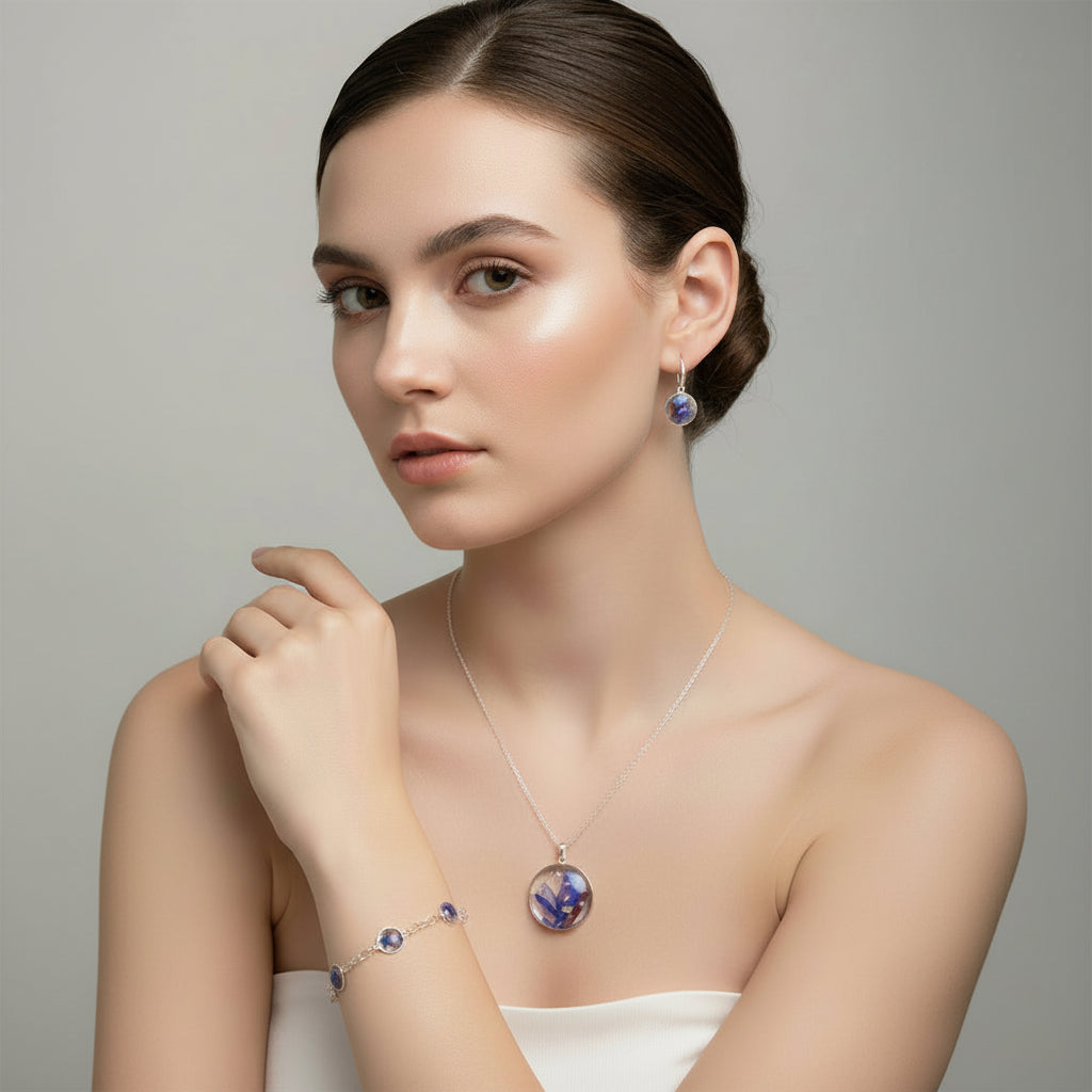 Woman wearing a necklace and earrings with a gray background