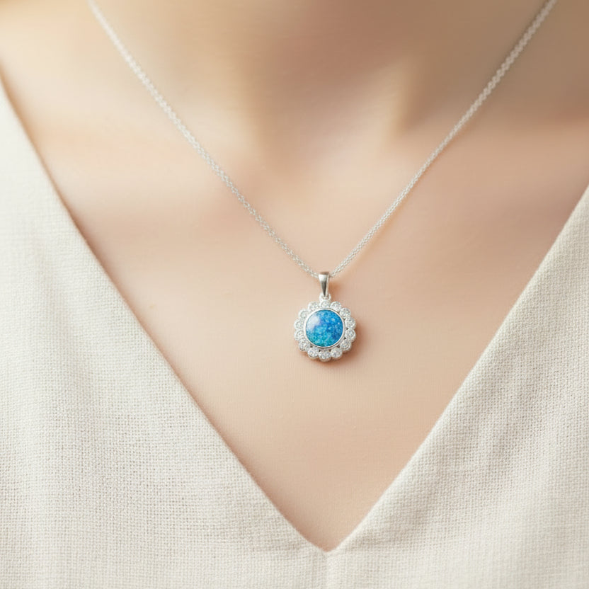 Necklace with a blue pendant on a mannequin wearing a white top