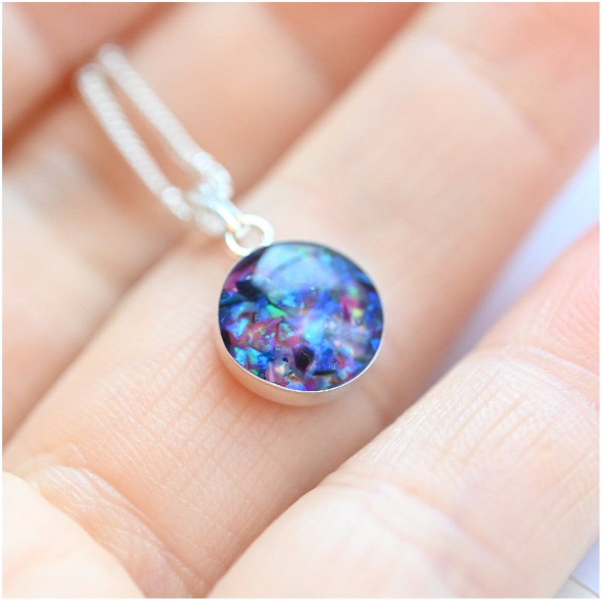 Close-up of Sterling Silver Memorial Circle Pendant Necklace – A 10mm or 12mm sterling silver circle pendant, custom-made with ashes, hair, or opal flakes, as a meaningful keepsake.