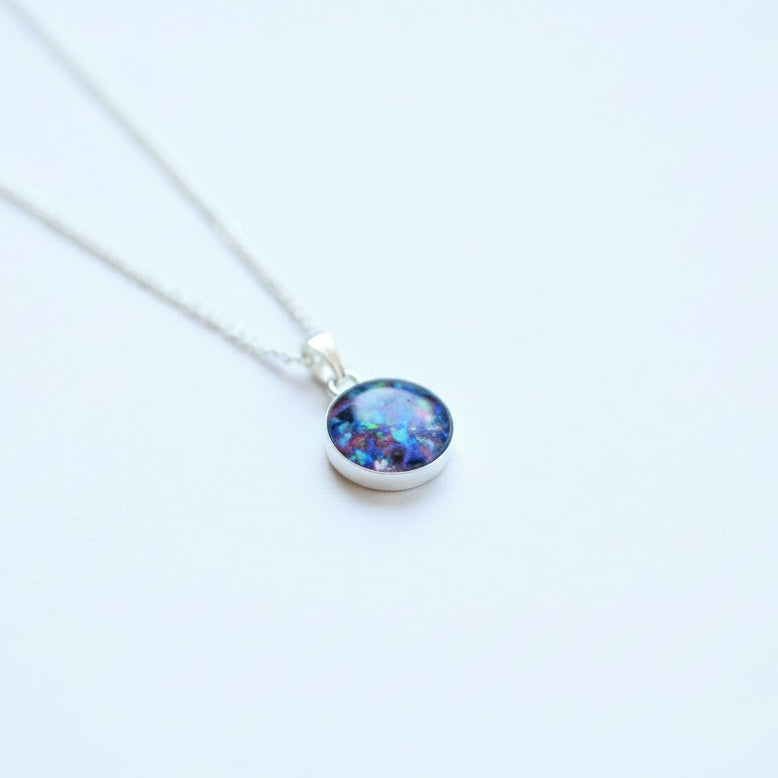 Close-up of Sterling Silver Memorial Circle Pendant Necklace – A 10mm or 12mm sterling silver circle pendant, custom-made with ashes, hair, or opal flakes, as a meaningful keepsake.