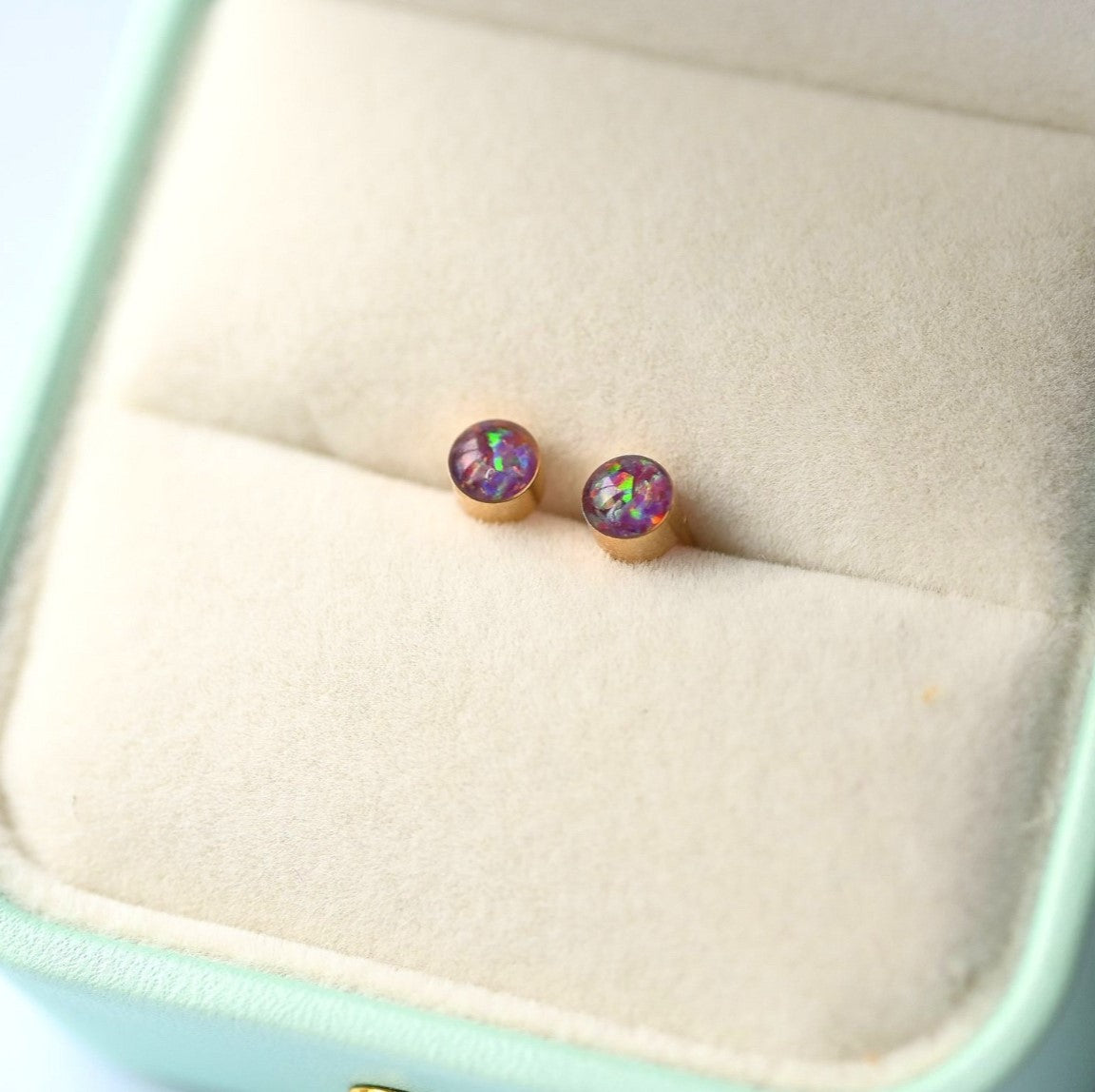 Dainty gold-filled memorial stud earrings, featuring cremation ashes and shimmering opal flakes.