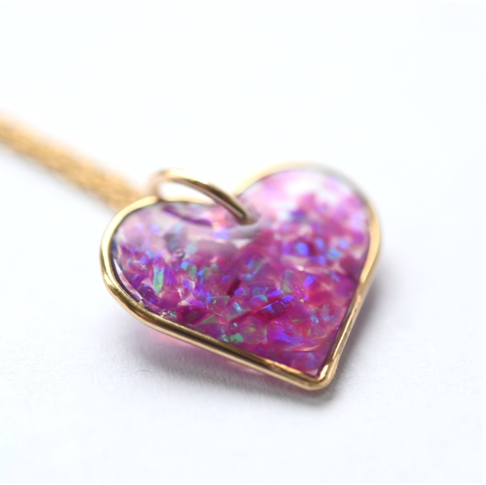 Elegant gold-filled memorial heart necklace with opal flakes, designed to hold ashes or hair, a timeless keepsake handcrafted in the UK.