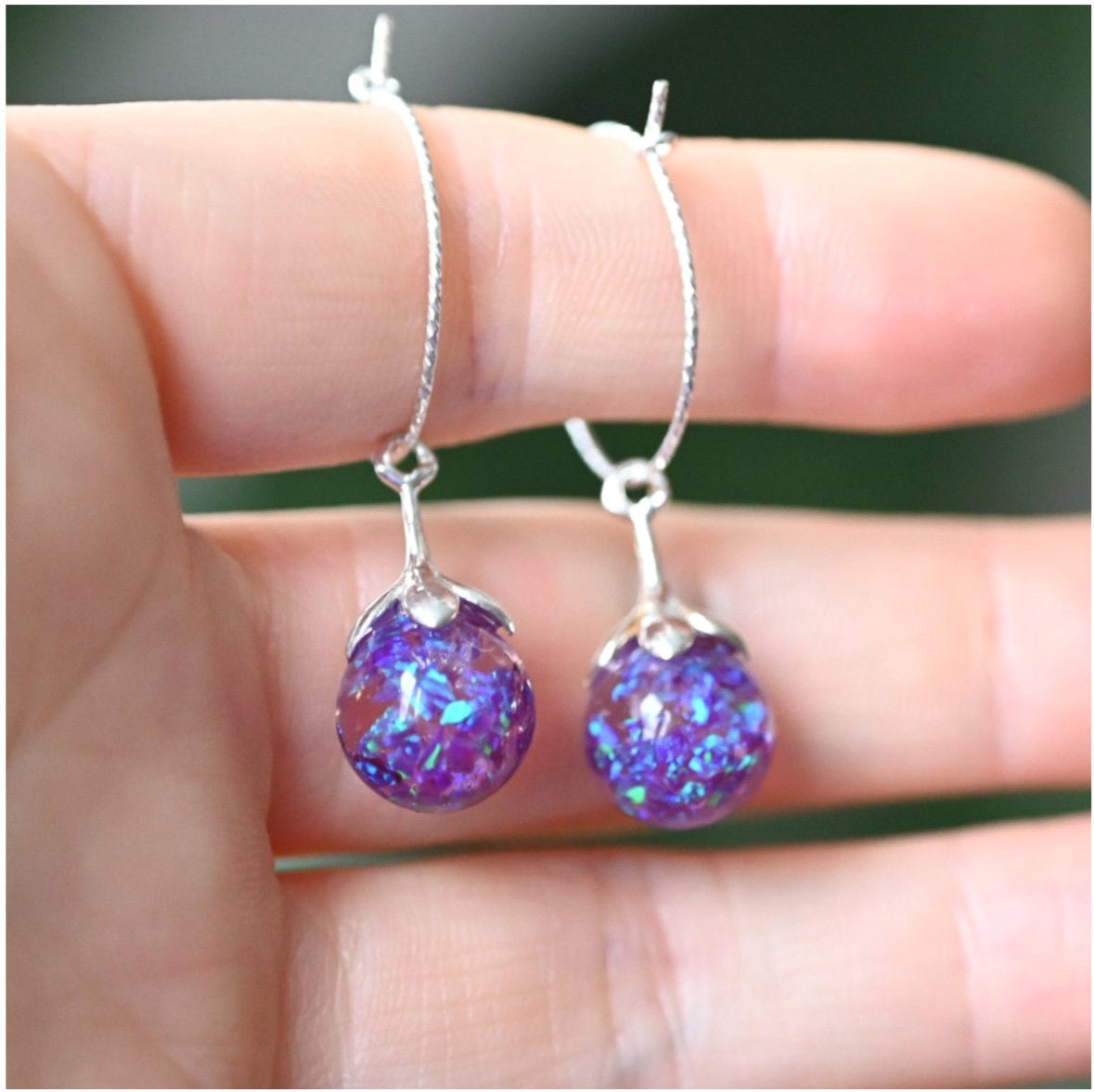 Close-up of Sterling Silver Hoop Earrings with Ashes & Opal Flakes – Elegant hoop earrings in sterling silver, featuring custom stones infused with cremation ashes and opal flakes for a unique memorial piece.