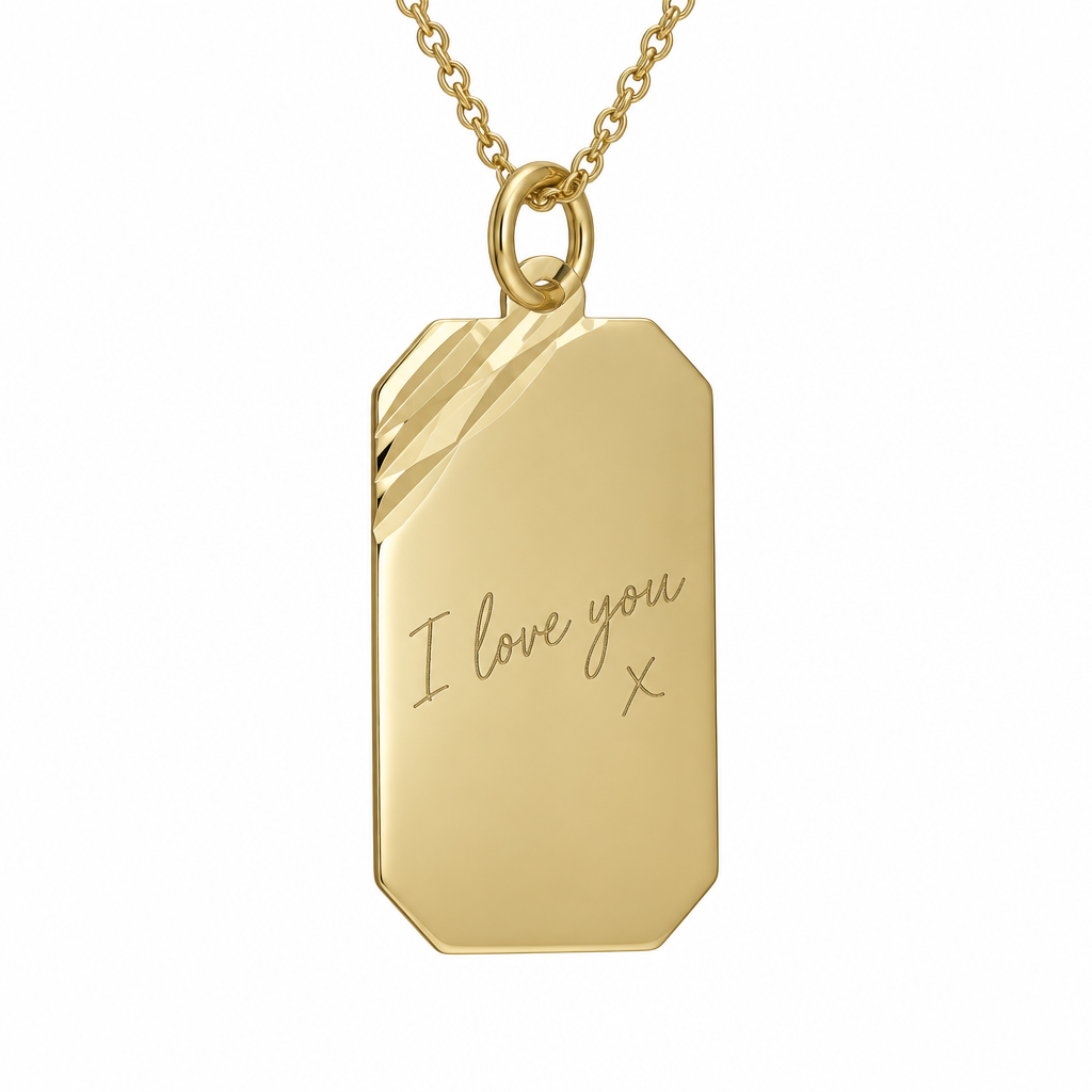 Illustrative handwriting engraving on 9ct yellow gold diamond-cut rectangular pendant with gold chain on white