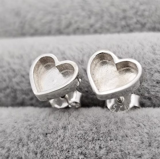 Silver 925 plain heart stud earrings showing butterfly backs on grey velvet