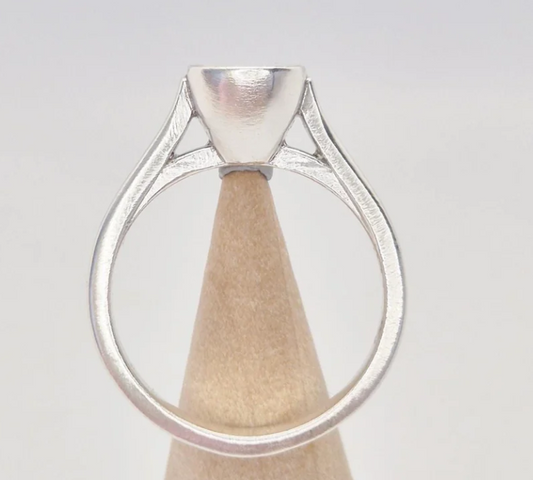 925 sterling silver 6mm cushion bezel cathedral memorial ring — back view on wooden cone showing open triangular cathedral shank cutouts