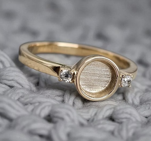 9K yellow gold round double gem CZ ring angled on grey knit fabric