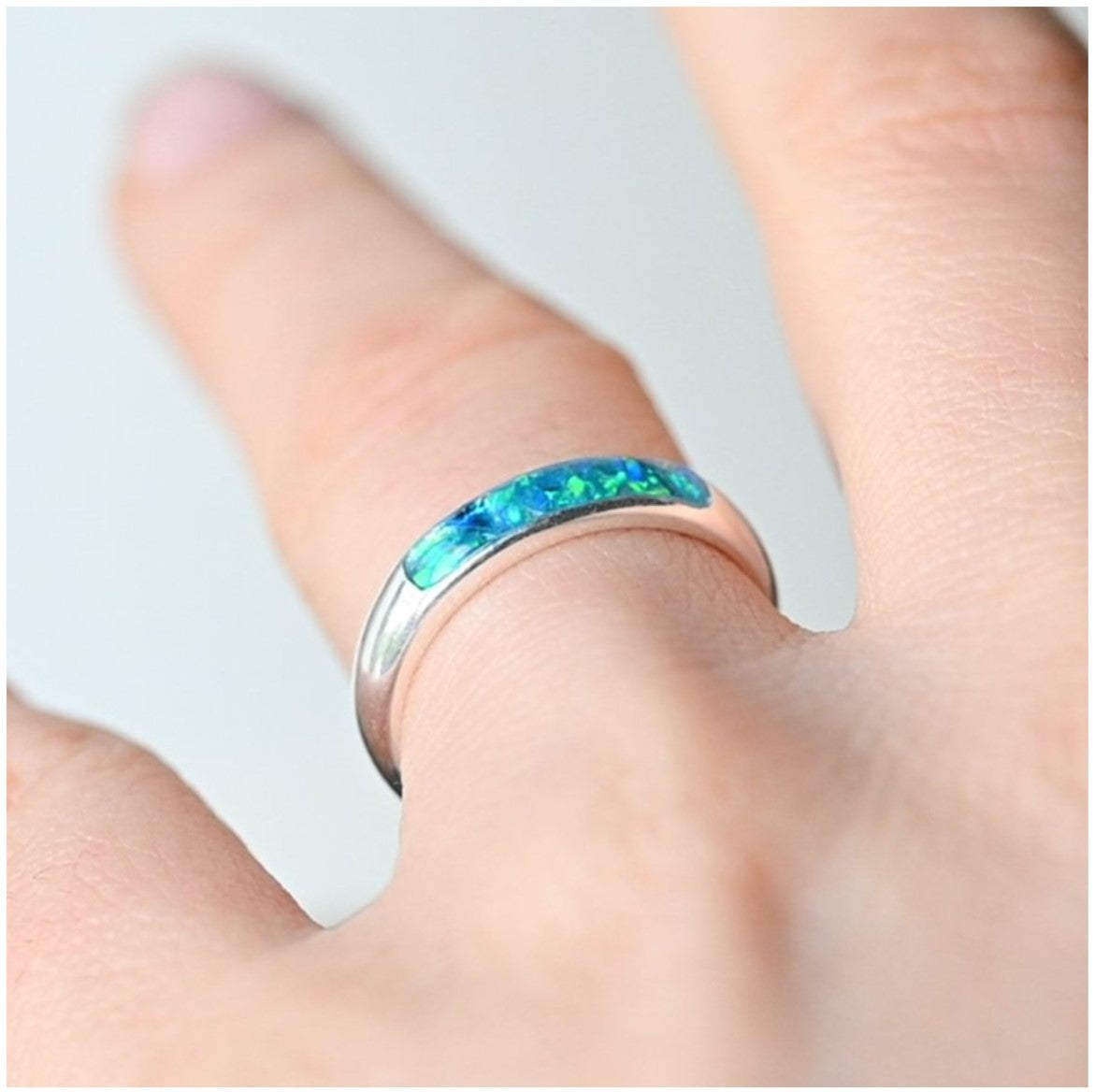 Ladies silver channel ring with opals and ashes worn on hand, showing off the elegant fit and unique design.