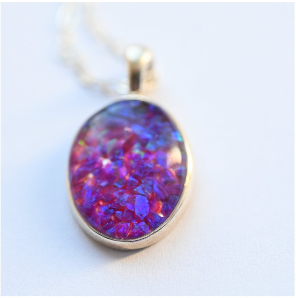 Sterling Silver Memorial Opal Flake Oval Pendant – A front view of the oval pendant filled with opal flakes, on a sterling silver chain, creating a unique tribute.