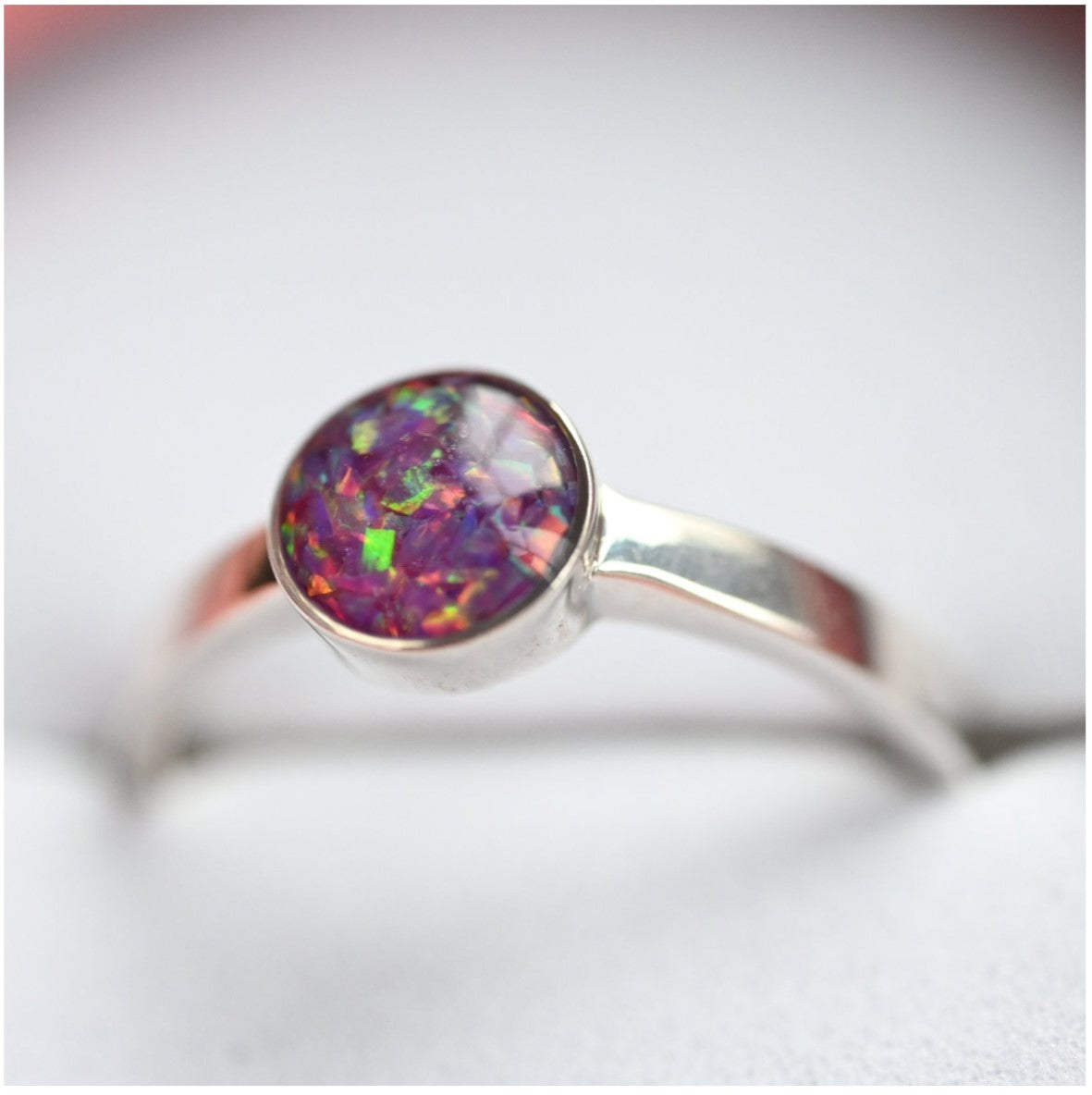 Side View of 6mm Round Memorial Ring with Opal Flakes – A side profile of the sterling silver memorial ring, showcasing the 6mm round design filled with opal flakes and sentimental items.