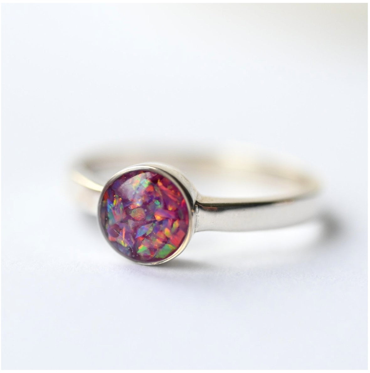 Close-up of Plain 6mm Round Memorial Ring with Opal Flakes – A simple yet elegant sterling silver ring with opal flakes, designed to hold ashes, hair, or sentimental objects.