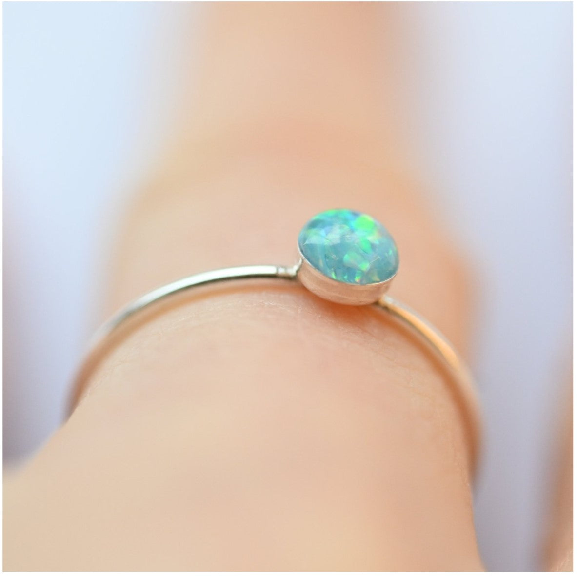 Close-up of Minimal Sterling Silver Memorial Stacking Ring with 4mm Stone – A delicate silver stacking ring featuring a 4mm memorial stone with ashes and opal flakes.