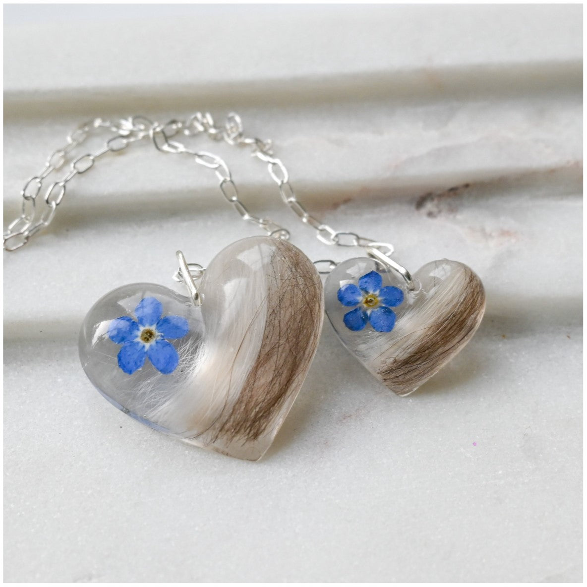 Personalised Fur Keepsake Necklace with Resin Heart Charms – A double-heart pendant necklace designed to hold pet fur and a forget-me-not flower in resin, creating a lasting memory.