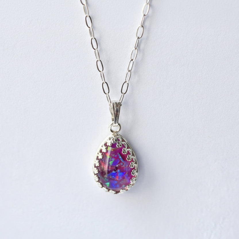 Close-up of Ashes and Opal Flakes in Teardrop Pendant – A zoomed-in shot of the teardrop pendant, showcasing the soft glow of opal flakes set within the ashes.