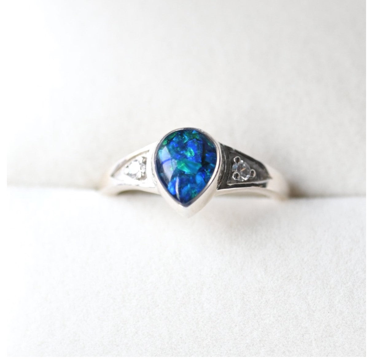 Side View of Teardrop Memorial Ring in Silver with Opal Flakes – A detailed side angle showcasing the elegant teardrop setting, with opal flakes adding a subtle shimmer to the memorial ashes.