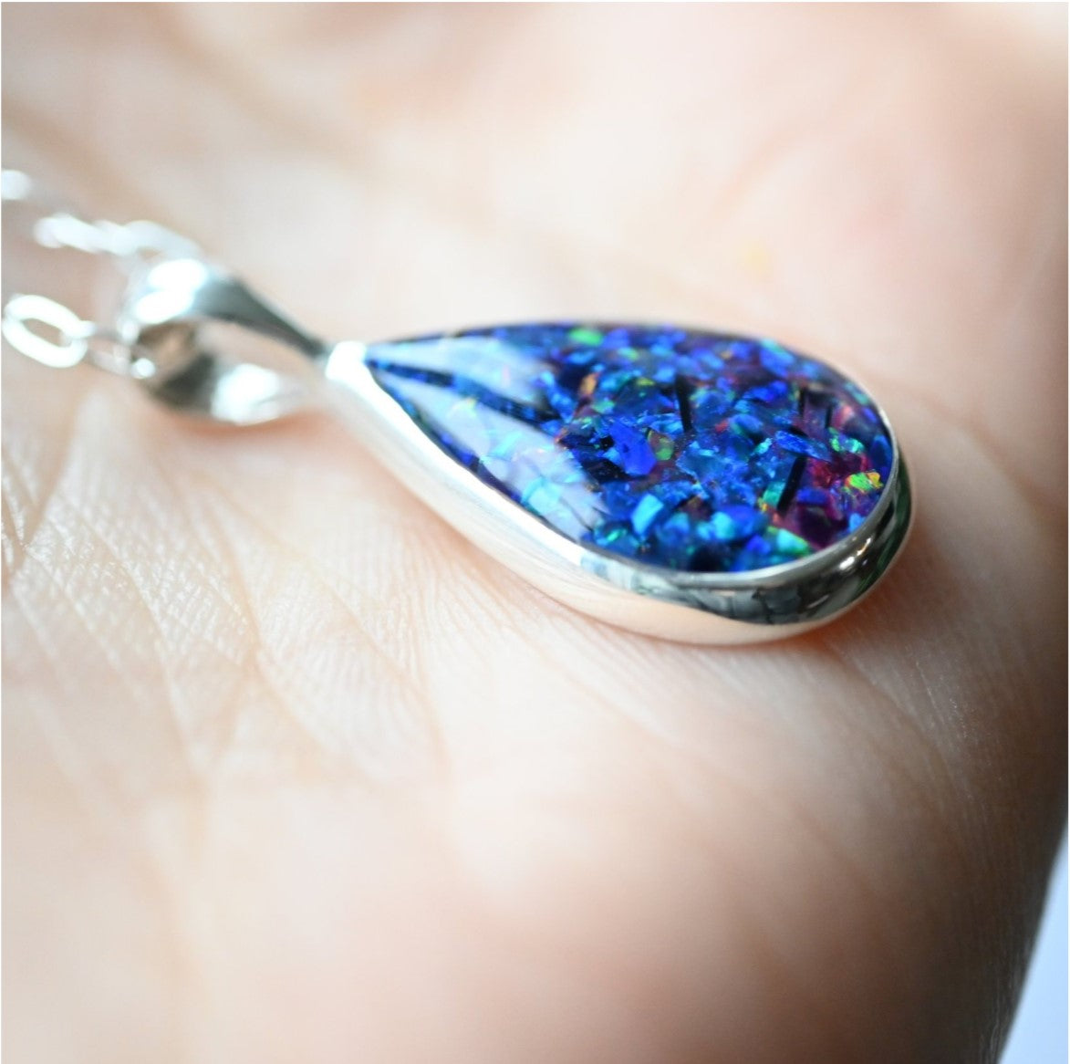 Memorial Ashes Necklace with Sterling Silver Chain – A sterling silver teardrop pendant with preserved ashes and opal flakes, displayed on a delicate silver chain.