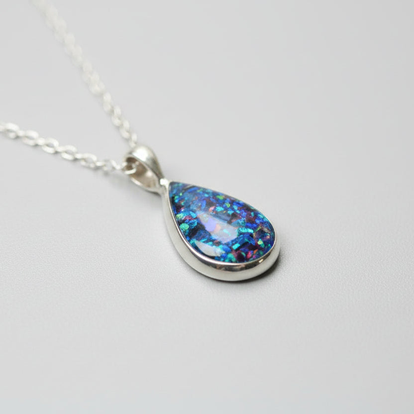 Close-up of Memorial Ashes Teardrop Necklace in Sterling Silver – A delicate teardrop pendant with preserved ashes and shimmering opal flakes, set in sterling silver for a timeless keepsake.