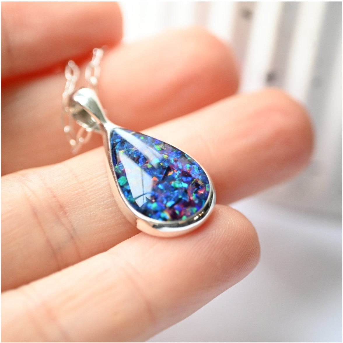 Close-up of Sterling Silver Memorial Ashes Teardrop Necklace – A delicate teardrop pendant with preserved ashes and shimmering opal flakes, set in sterling silver for a timeless keepsake.