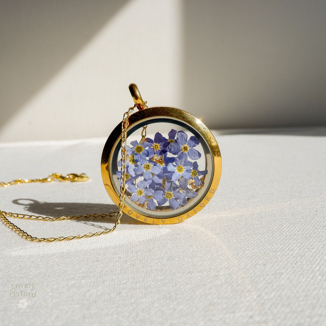 Forget-me-not glass locket necklace with real flowers — handcrafted by Lovely Oxford