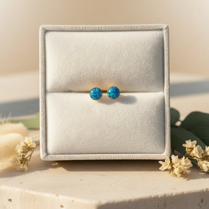 Side view of handcrafted memorial stud earrings with preserved ashes and opal, a delicate remembrance piece.