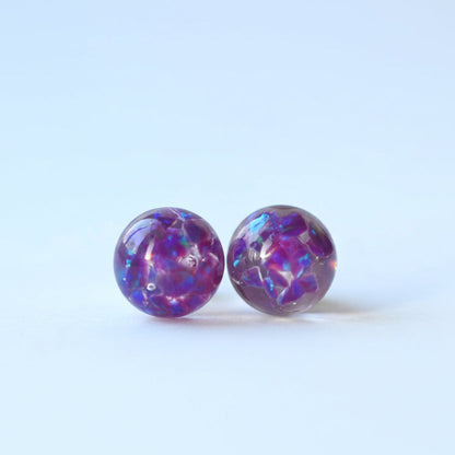 Close-up of 8mm memorial stud earrings with crushed opals and ashes, handcrafted in silver or gold-filled, made in the UK for a meaningful and lasting keepsake.