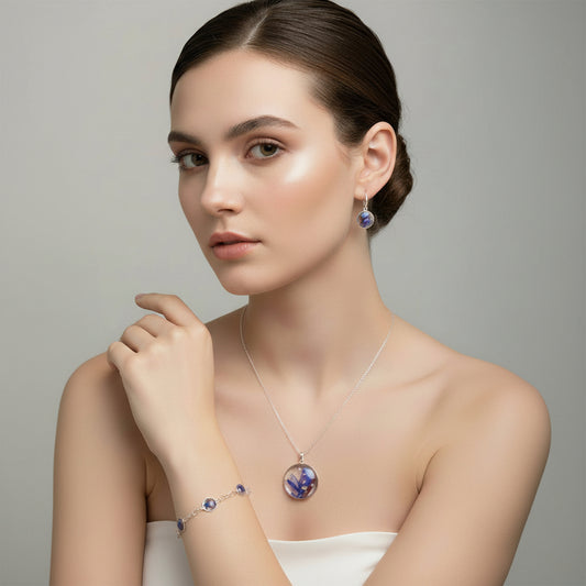 Woman wearing a necklace and earrings with a gray background