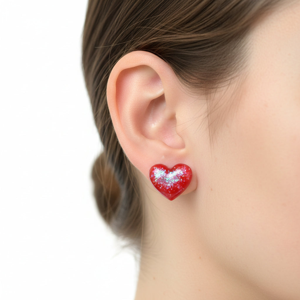 Heart-shaped red and glittery resin objects on white cards.