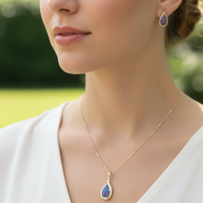 Teardrop-shaped jewelry set with purple stones on a hand