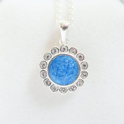 Blue pendant necklace with silver chain on a white background