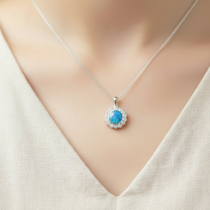 Necklace with a blue pendant on a mannequin wearing a white top