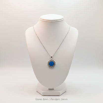 Necklace with a blue pendant on a white mannequin bust against a white background
