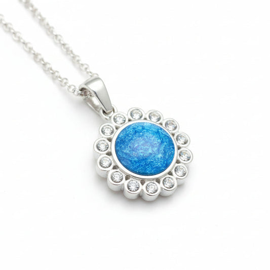 Silver necklace with a blue pendant on a white background
