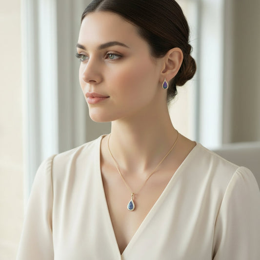Woman wearing a necklace and earrings with a neutral background