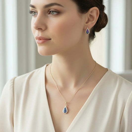 Woman wearing a necklace and earrings with a neutral background