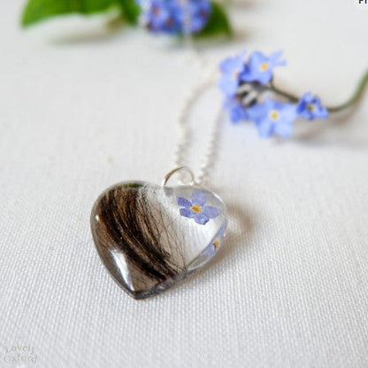 Heart-shaped pendant with floral design on a white background