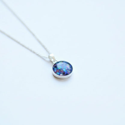 Close-up of Sterling Silver Memorial Circle Pendant Necklace – A 10mm or 12mm sterling silver circle pendant, custom-made with ashes, hair, or opal flakes, as a meaningful keepsake.