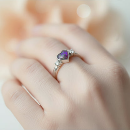 Close-up of a heart-shaped double gem memorial ring with ashes, offering a handmade sterling silver design for a personalised tribute.