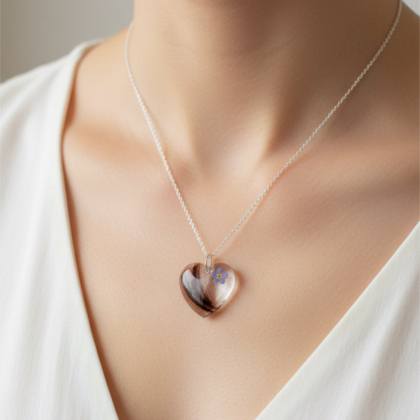 Heart-shaped pendant necklace on a mannequin with a neutral background