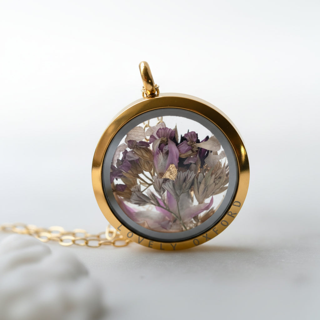 Gold locket with dried flowers on a white background
