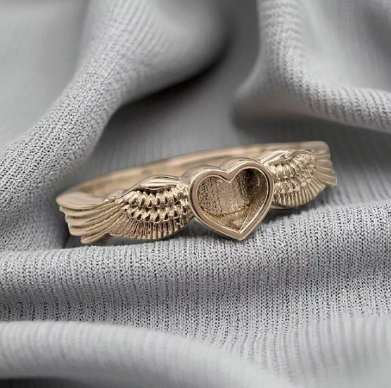 9ct gold heart angel wing ring front view showing two feathered wings embracing heart bezel on plain band