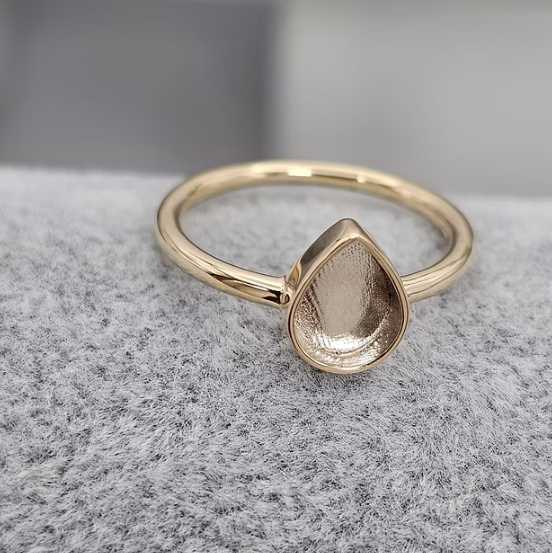 9ct yellow gold plain teardrop ring angled side view showing pear bezel sitting proud on fine plain band