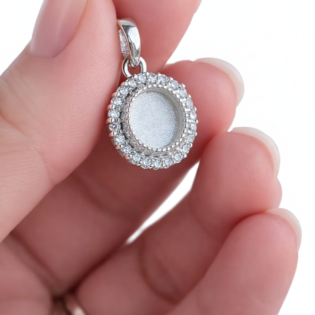 Round Halo CZ 925 Silver Memorial Pendant held in hand — white background