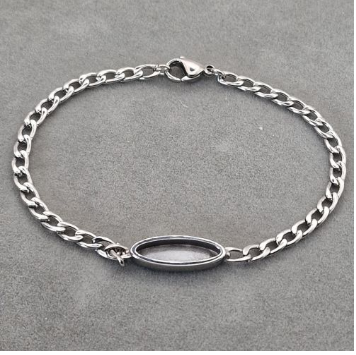 Stainless steel curb chain bracelet with oval bezel centrepiece blank showing delicate chain links and lobster clasp