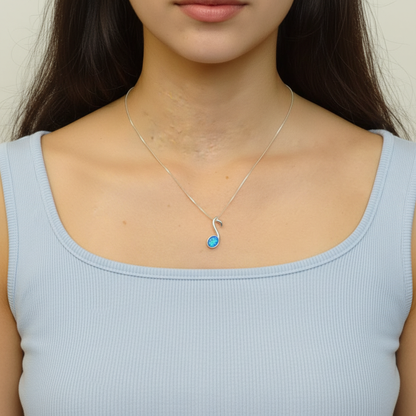 Model wearing silver 925 quaver music note memorial pendant at true 21x7mm scale