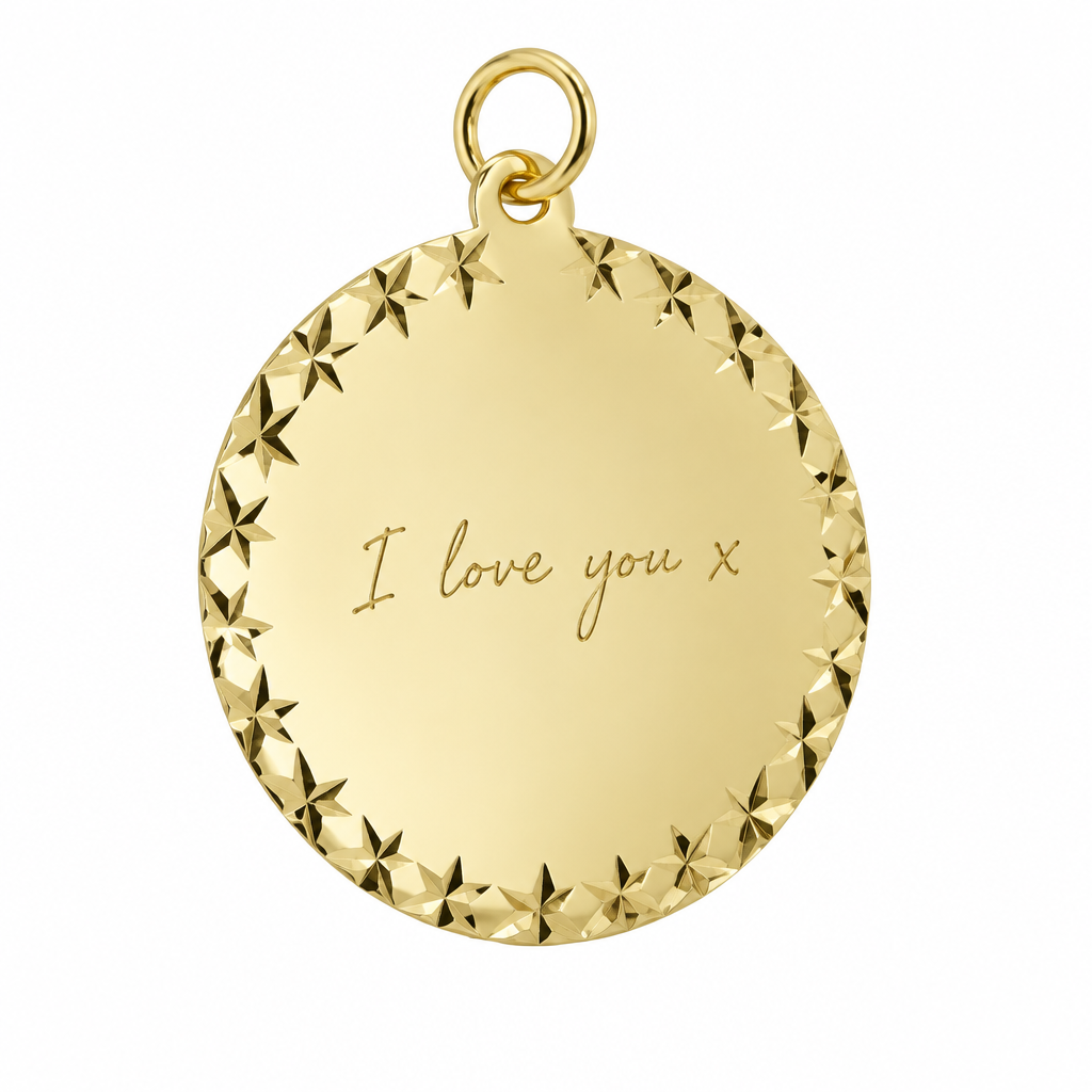 Illustrative handwriting engraving on 9ct yellow gold round pendant with X-cut border on pure white background