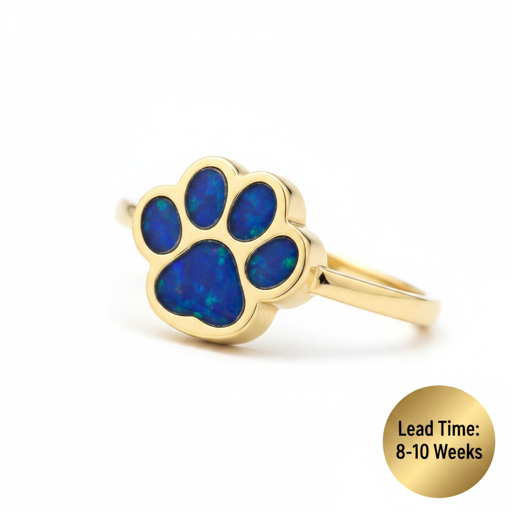9ct yellow gold paw print memorial ring with deep blue sapphire opal resin in paw pads, white background, lead time 8-10 weeks