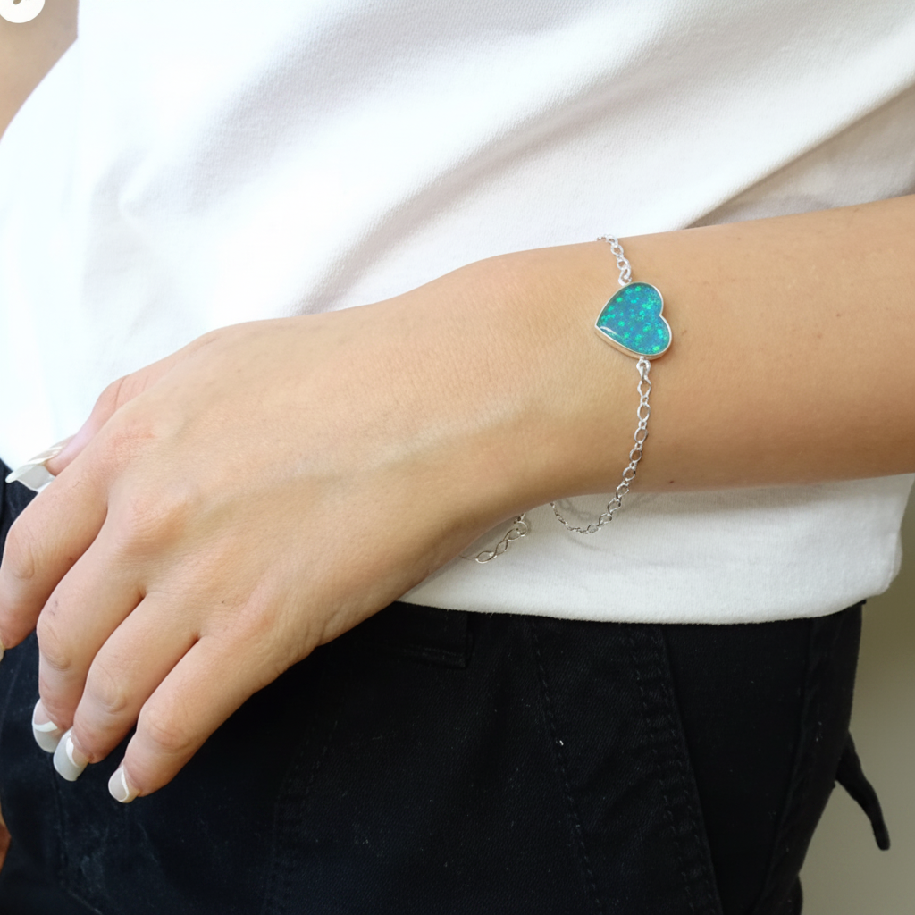 Silver 925 heart memorial bracelet worn on model wrist — blue teal opal resin in heart setting, true scale lifestyle shot