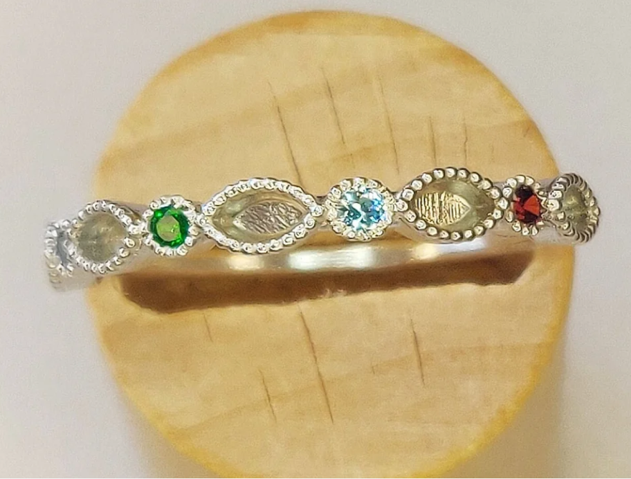 Argentium silver birthstone eternity band — top view showing alternating marquise milgrain settings and round birthstone gems in multiple colours